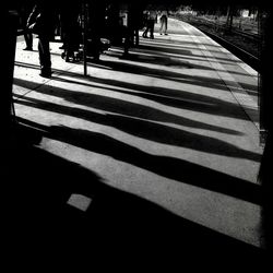 Low section of woman walking on zebra crossing