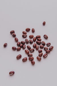 High angle view of coffee beans over white background