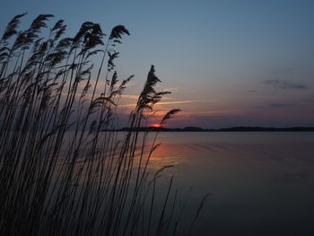 Scenic view of sea against romantic sky at sunset