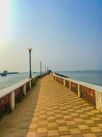 View of pier over sea against clear sky