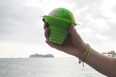 Girl is holding ice cream - cruise ship in the background