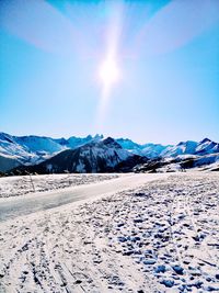 Scenic view of snow covered mountains against sky