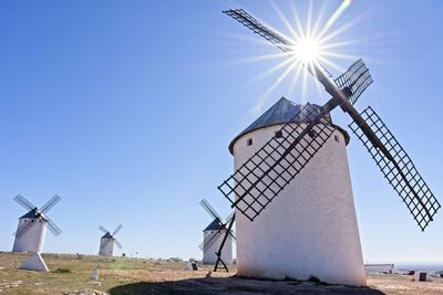 Traditional windmill on field against sky