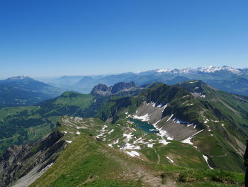 Scenic view of mountains against clear blue sky