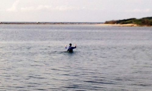 Man surfing in sea against sky