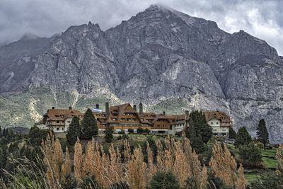 Panoramic view of houses and trees against sky