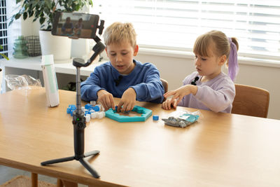 Siblings playing on table