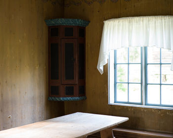 Wooden table by window at home