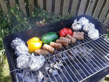 High angle view of vegetables on barbecue grill in yard