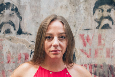 Portrait of woman against wall