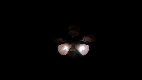 Low angle view of illuminated pendant light hanging from ceiling