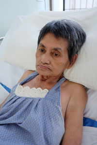 High angle view of woman lying on bed in hospital