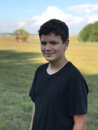 Portrait of teenage boy standing on field