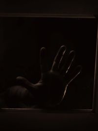 Close-up of human hand against black background