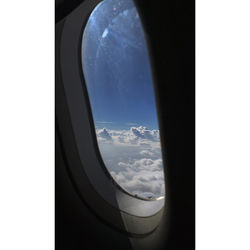 Close-up of glass window against sky