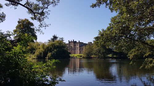 Reflection of trees in lake against sky