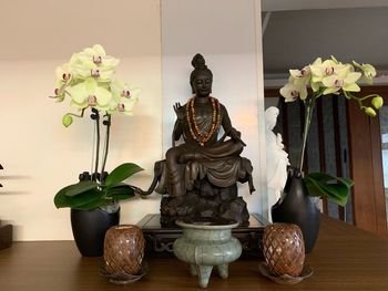 Buddha statue on table at home