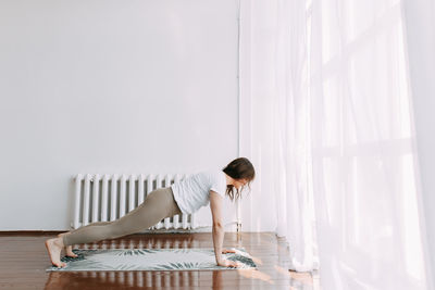 Woman sitting on floor at home