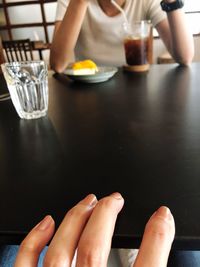 Low section of woman sitting at table