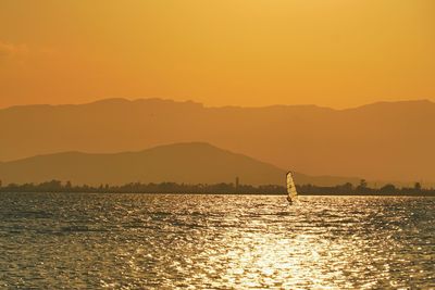 Scenic view of sea against orange sky