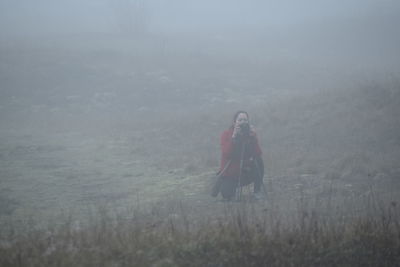 Woman standing on snow covered land