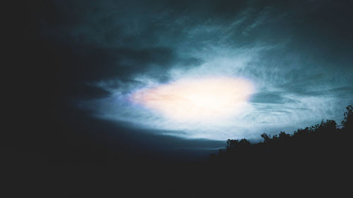 Low angle view of silhouette trees against sky at night