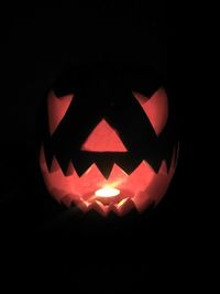 Close-up of illuminated pumpkin against black background