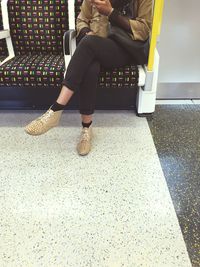 Low section of woman standing on tiled floor