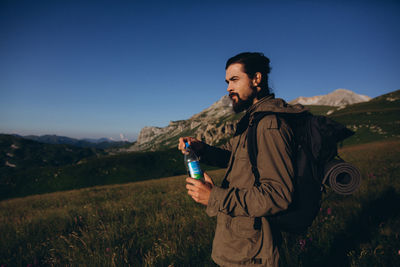 Man standing on field against clear sky