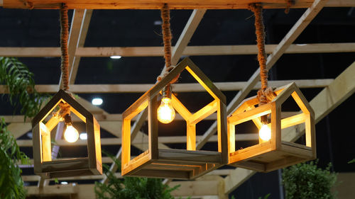Low angle view of illuminated lights hanging from roof
