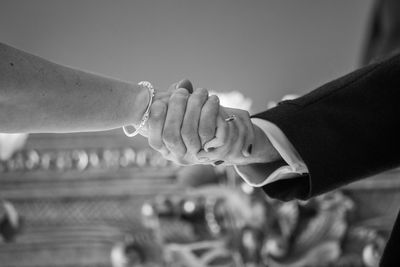 Midsection of couple holding hands