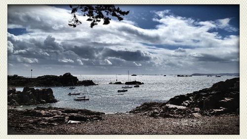 Scenic view of sea against cloudy sky