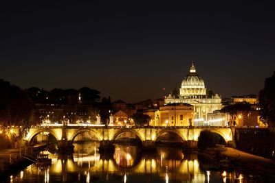 View of bridge over river at night