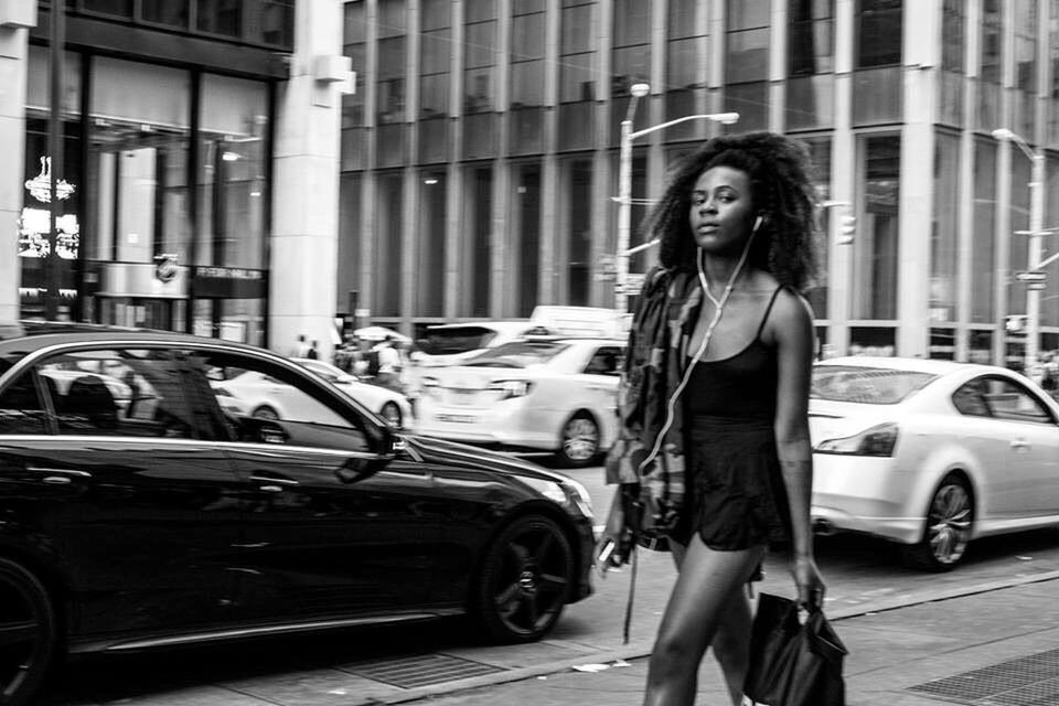 PEOPLE WALKING ON ROAD IN CITY