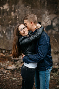 Portrait of young couple standing outdoors