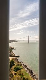 View of suspension bridge over sea