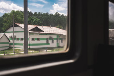 View of train through window of building
