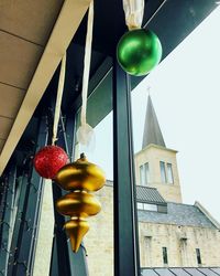 Low angle view of balloons hanging on window