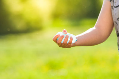 Cropped hand of woman holding balloon