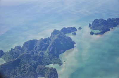 Close-up of rocks by sea against sky