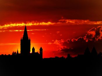 Silhouette buildings against sky during sunset