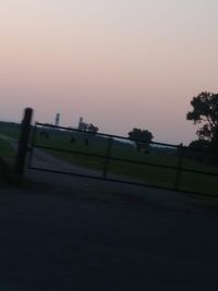 Scenic view of field against clear sky during sunset