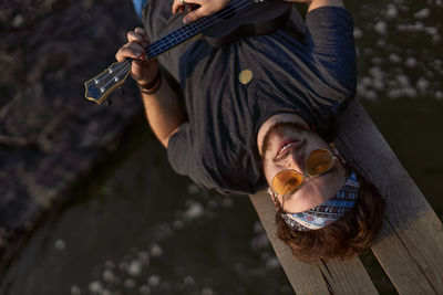 High angle view of man playing guitar