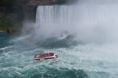 View of boat at waterfall