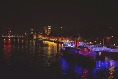 Boats in lake at night