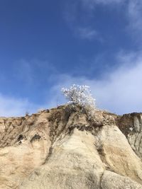 Low angle view of rock formations against sky