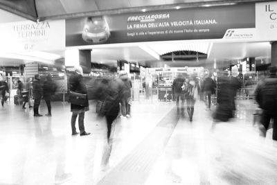 People walking on illuminated subway station