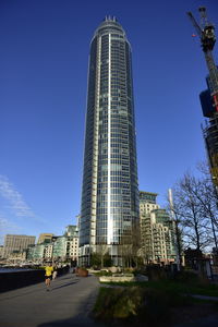 Low angle view of modern buildings against clear blue sky