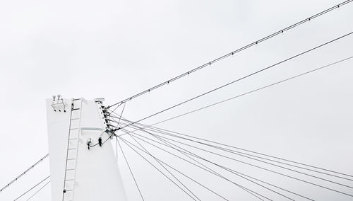 Low angle view of electricity pylon against sky