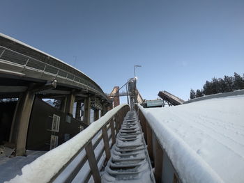 Low angle view of steps and building against clear sky